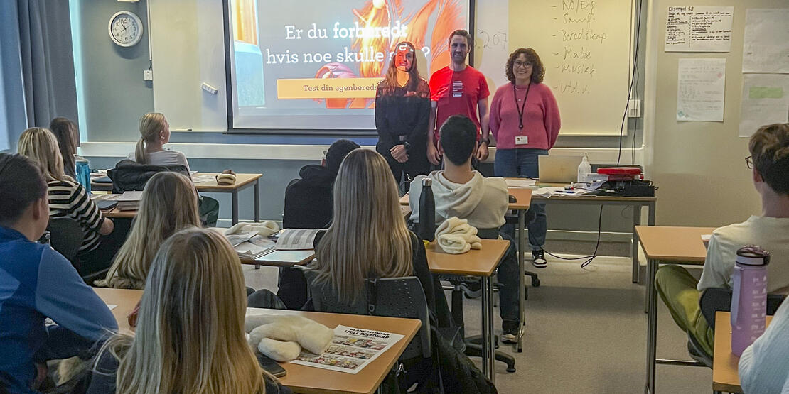 Bildet viser tre personer som holder foredrag foran elever i et klasserom. Lysbilde med innhold fra en av kampanjene under Egenberedskapsuka 2023. 